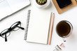 © voyata - Business concept - Top view of white desktop background with notebook, coffee, smart phone, cactus and clip for mockup design