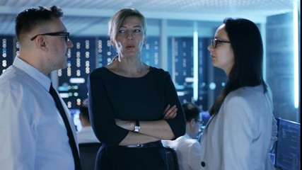 Aufkleber - Three System Engineers Have Discussion on Monitoring Room. In the Background People Working with Multiple Displays Showing Useful Data. Shot on RED EPIC-W 8K Helium Cinema Camera.