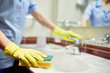 © pressmaster - Janitor cleaning sink in hotel room