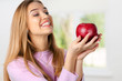 © fotofabrika - Smiling woman holding red apple