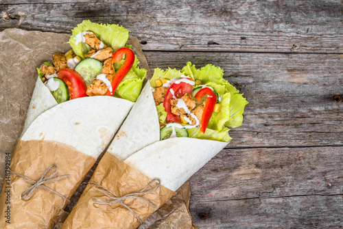 Fotografie, Obraz Delicious tortilla wraps, burritos filled with grilled chicken and vegetables, m