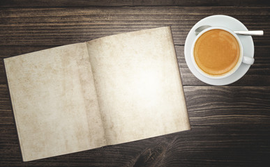 Wall Mural - top view of rustic wood table surface with blank notebook diary and a delicious cup of hot coffee