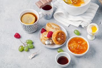 Wall Mural - Morning atmosphere. Healthy breakfast with porridge, oatmeal, pancakes, lots of berries and snacks on blue rustic background.