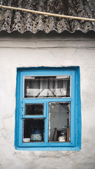 Minimalism scene with a Side wall of damaged building with blue old vintage window