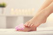 © Kalim - Soft female feet with french pedicure and flowers close up