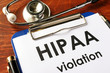 HIPAA violation form on a clipboard. Medical confidentiality concept.