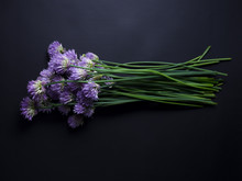 Freshly Picked Chives With Purple Flowers Isolated On Black Background
