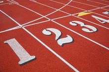 Red Running Track In Sport Field With Multiple Lanes