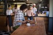 © WavebreakMediaMicro - Young man using digital tablet in restaurant