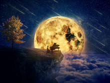 Night Scene With A Boy, Musician Standing At The Edge Of A Cliff Chasm With His Piano. Waiting For Music Inspiration In The Center Of Nature, Over A Full Moon Night Background