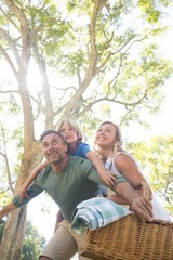 Wall Mural - Family arriving in the park for picnic on a sunny day