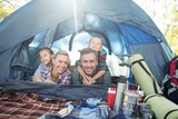 Fototapeta  - Smiling family lying in the tent