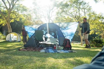 Wall Mural - Father and son setting up a tent