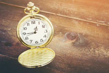 Pocket watch on wooden background