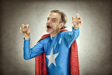 Senior Superhero Man In Blue Costume Red Cloak And Mask Old Portrait On Textured Background