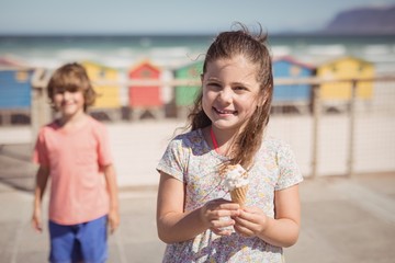 Wall Mural - Portrait of smiling girl holding ice cream