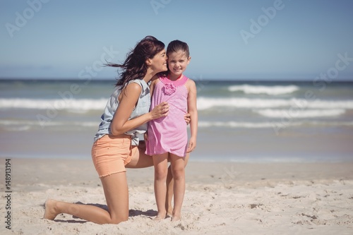 Happy Mother Kissing Her Daughter At Beach Kaufen Sie Dieses Foto Und