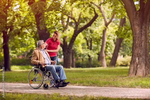 Fotografie, Obraz senior man in wheelchair in the park with daughter.