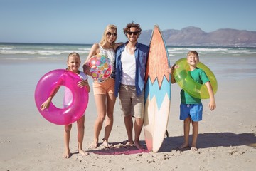 Wall Mural - Portrait of happy family standing at beach