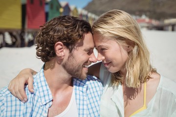 Wall Mural - Happy couple looking face to face at beach