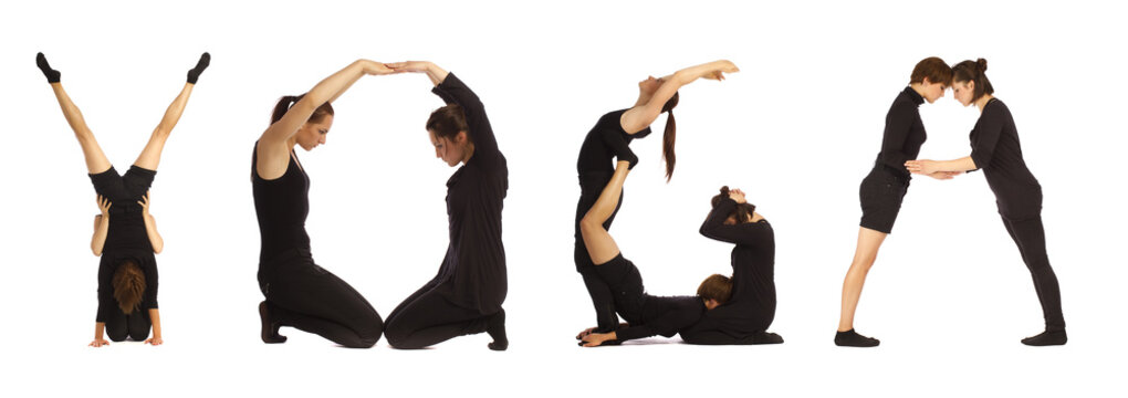 Black dressed people forming word YOGA