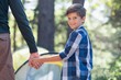 © WavebreakMediaMicro - Smiling boy with father hiking in forest