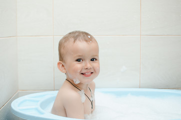 Wall Mural - Happy baby boy taking a bath