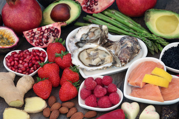  Aphrodisiac food to promote sexual health with foods in heart shaped dishes and loose over marble background.
