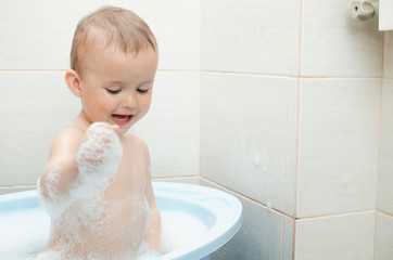 Wall Mural - Happy baby boy taking a bath