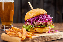 Sandwith with pulled pork and french fries on wooden background