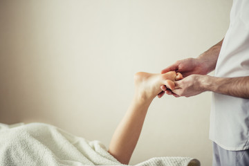 Wall Mural - Masseur massaging little girl foot.