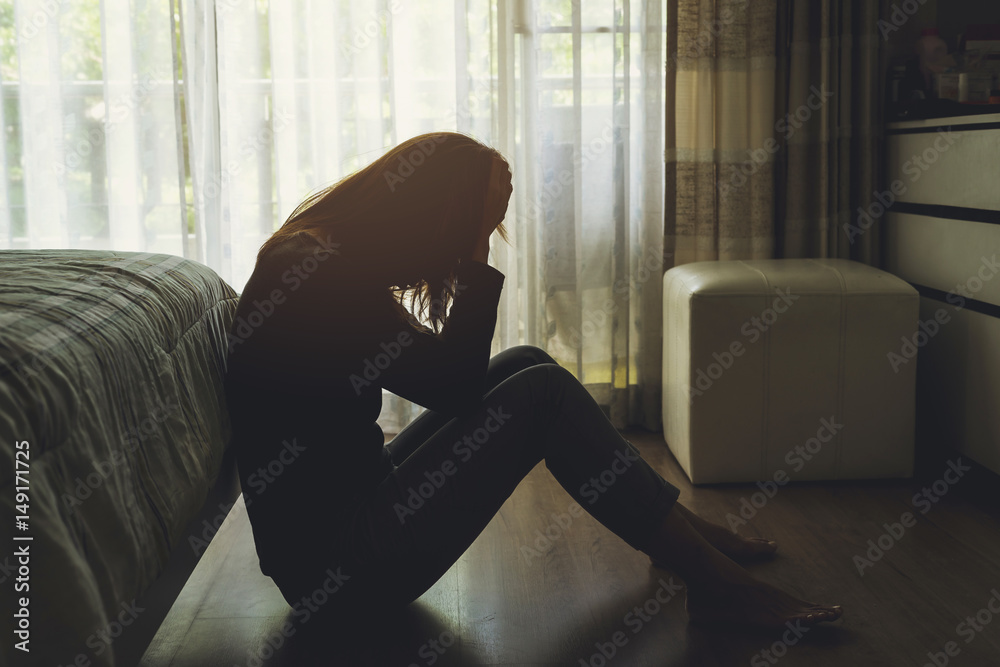 Lonely young woman feeling depressed and stressed sitting head in hands in the dark bedroom, Negative emotion and mental health concept - obrazy, fototapety, plakaty 