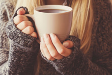 Young Woman's Hands Holding A Mug And Warming With Hot Coffee.