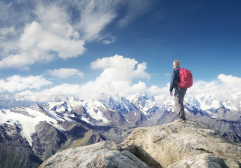 Tourist on the mountain range in the clouds. Active life concept