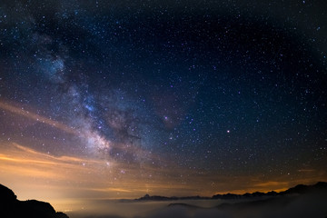 Wall Mural - the colorful glowing core of the milky way and the starry sky captured at high altitude in summertim