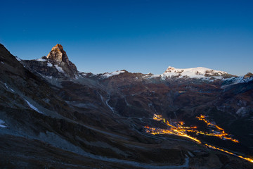 Wall Mural - aerial view of breuil cervinia village glowing in the night, famous ski resort in aosta valley, ital