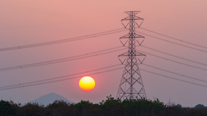 High voltage transmission cable on the post with sunset background