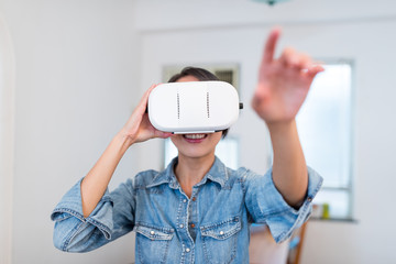 Wall Mural - Woman looking with virtual reality device