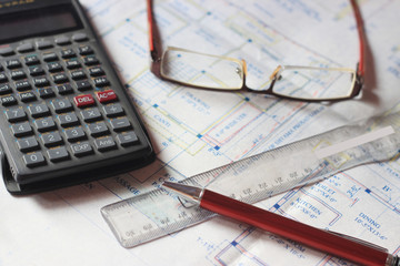 Calculator and building plans. Building planes for a new house, isolated.