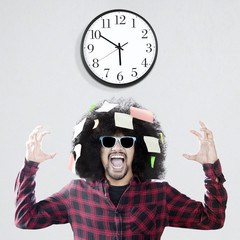 Wall Mural - Frustrated Afro man with wall clock