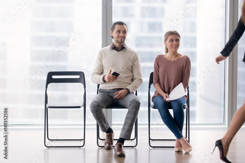Confident Businesswoman Walking By Male And Female Job
