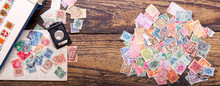 Old Postage Stamps And Magnifying Glass