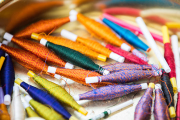 assortment of silk thread spools of different shades of color