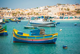 Fototapeta  - fishing boats near fishing village of Marsaxlokk (Marsascala) in Malta