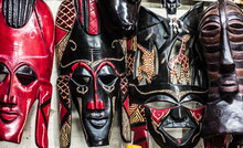 Different Colorful Tribal Wooden Masks At African Souvenir Market