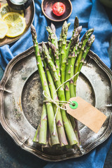 Wall Mural - Asparagus bunch with blank paper label , top view, close up, copy space