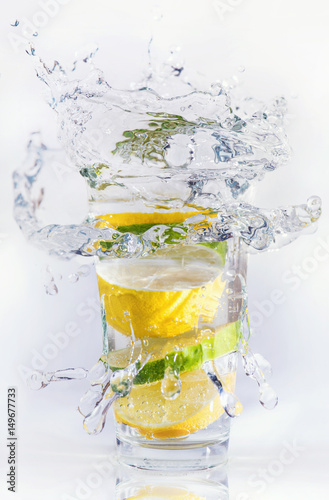 Naklejka na szybę Lemons and limes in the glass. Concept and idea of drink