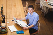 © aemstock - Young guy read a newspaper in the Italian style kitchen
