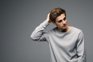 Portrait of sexy fashion man on grey background