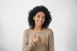 © wayhome.studio  - I like that. Good job. Happy young dark skinned female wearing casual long sleeved t-shirt making thumbs up sign and smiling cheerfully, showing her support and respect to someone. Body language